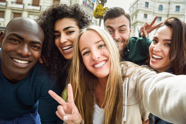 Free photo multiracial group of young people taking selfie